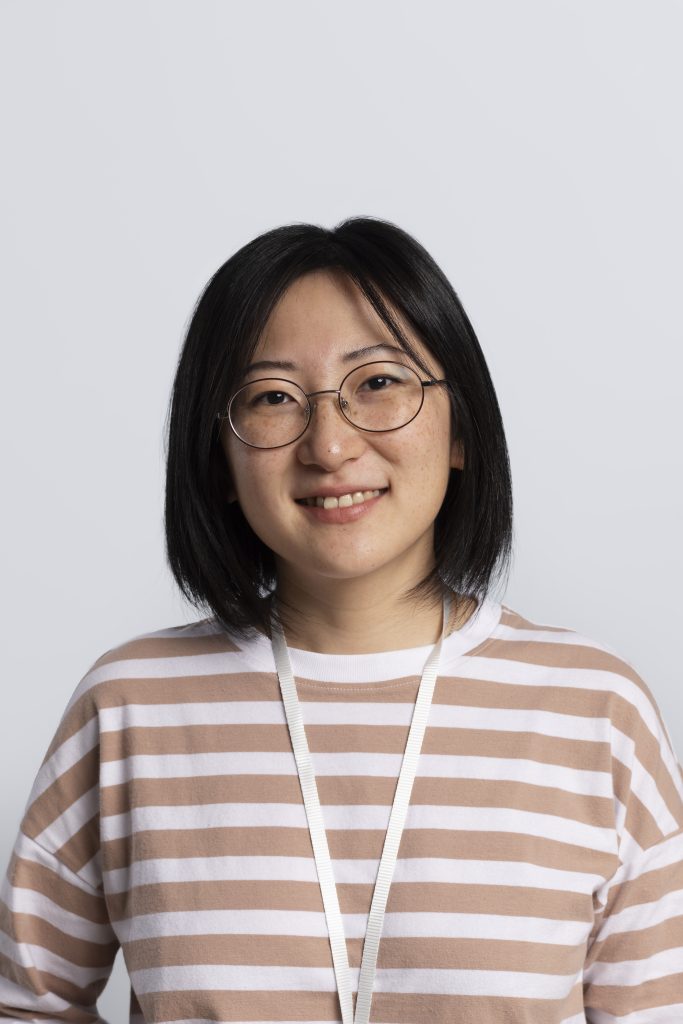 Portrait of a woman standing straight and smiling